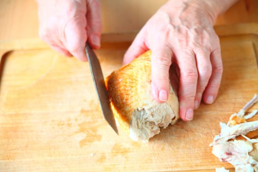 A man ready to slice a Thanksgiving turkey breast