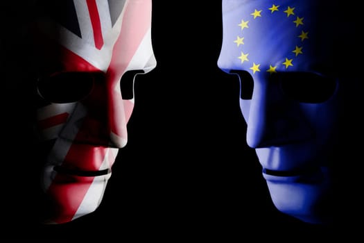 Brexit UK EU concept with face masks for each side and country flag texture on face. Black background.