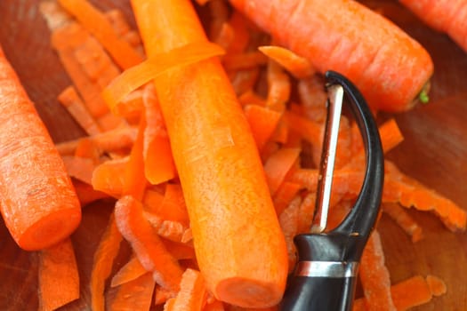 Closeup of raw carrots being peeled