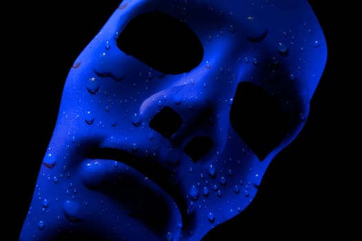 Blank robot face with blue water texture for skin. AI concept with close up human like features. Black background.