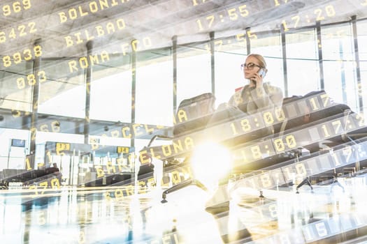Graphic image of woman talking on her mobile phone while waiting to board a plane at the departure gates at the airport terminal. Flight information board text overlaid. Transportation concept.