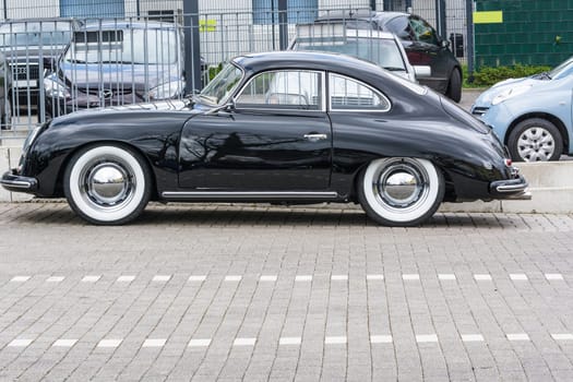 VELBERT, NRW, GERMANY - APRIL 06, 2016:.Black vintage Porsche 1600 with whitewall tires on a car park in Velbert city center, Germany...