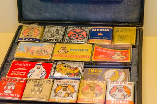 HAGEN, NRW, GERMANY - JULY 24, 2014:.Hagen, Germany antique suitcases with various tobaccos cans.packed up.