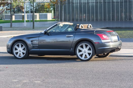 ESSEN, NRW, GERMANY - OCTOBER 11, 2015:.Chrysler Crossfire, side view of the new administrative building of ThyssenKrupp in Essen, Germany..