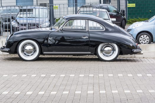 VELBERT, NRW, GERMANY - APRIL 06, 2016:.Black vintage Porsche 1600 with whitewall tires on a car park in Velbert city center, Germany...