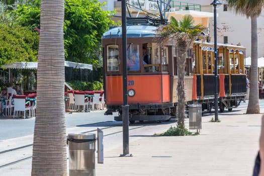 PORT DE SOLLER, SPAIN - JUNE 02, 2016: Vintage train, tram on the beach promenade of the town of Soller in Spain. Opened in 1913, the driving distance is about 5 km long.