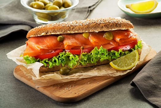 Sandwich with smoked salmon salad and tomato. Healthy food.