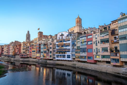 Colorful buildings on the Onyar River in Girona, Spain taken during the blue hour