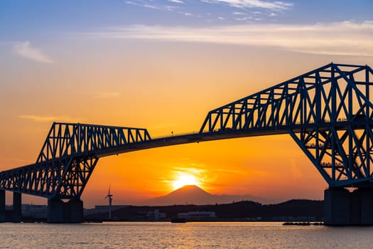 Diamond Fuji in Tokyo with Tokyo Gate Bridge, natural phenomenons that sun move pass mountain Fuji while sunset in Tokyo Japan. This happen only 2 times once a year.