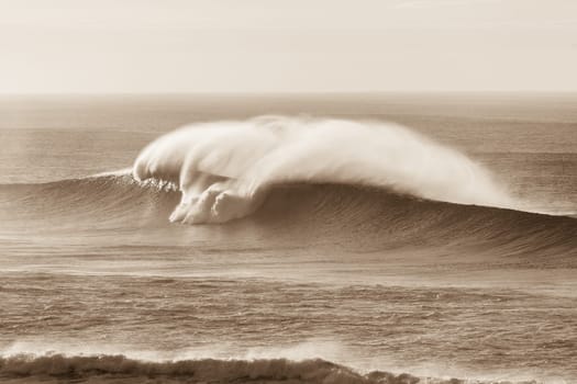 Wave crashing hollow water ocean sea power with spray vintage sepia tone