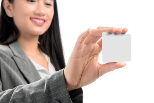 Pretty asian business woman showing blank business card on her hand standing isolated over white background