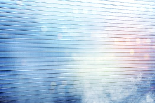 White roller shutter door with smoke and colorful light reflection on metal background