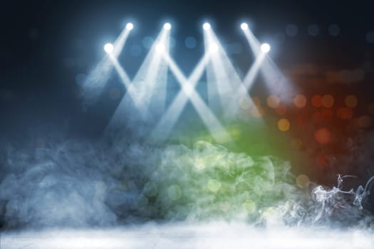 Tile floor with concert spot lighting and smoke with defocused colorful lights background