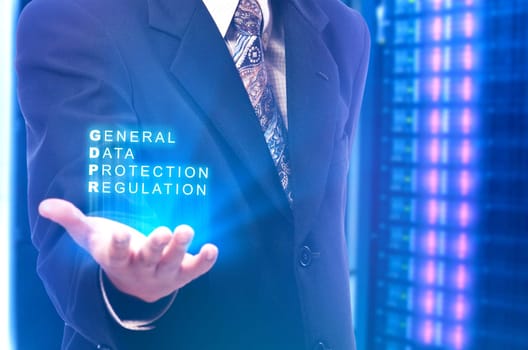 Businessman showing General Data Protection Regulation text on his hands with modern storage of server on the data center on the background. Cyber security and privacy. General Data Protection Regulation (GDPR) concept