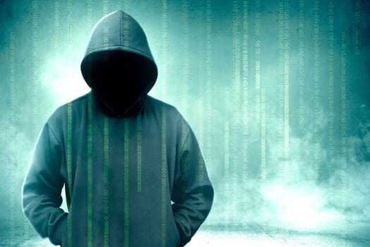 Hacker in black hoodie standing with binary code on virtual screen over green background