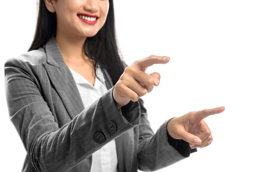 Smiling asian business woman touch something with her both finger hands standing isolated over white background