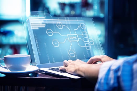 Businessman working using laptop with virtual screen display the GDPR protection structure and binary with coffee on the table at office room background. Cyber security and privacy. General Data Protection Regulation (GDPR) concept
