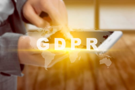 Business woman touching the mobile phone screen and display GDPR text and worldwide maps with office room background. Cyber security and privacy. General Data Protection Regulation (GDPR) concept
