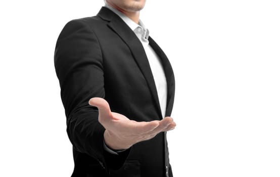 Businessman in suit standing with open palm for offer shake hands and holding or showing something isolated over white background