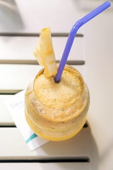 Pineapple juice cocktail with fresh pineapple piece.