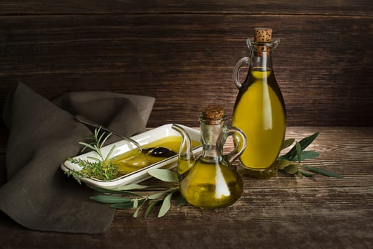 Healthy olive oil with herbs pouring in to plate close up