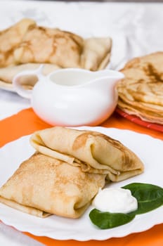 stack of pancakes with stuffing on a white plate
