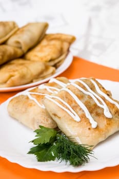 stack of pancakes with stuffing on a white plate