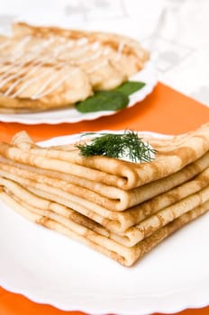 a stack of russian pancakes on a white plate