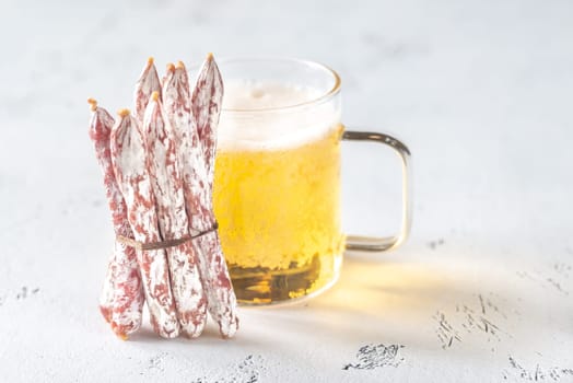 Snack fuet sausages with glass mug of beer