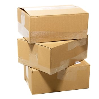 Three closed cardboard boxes packed with goods ready for shipping