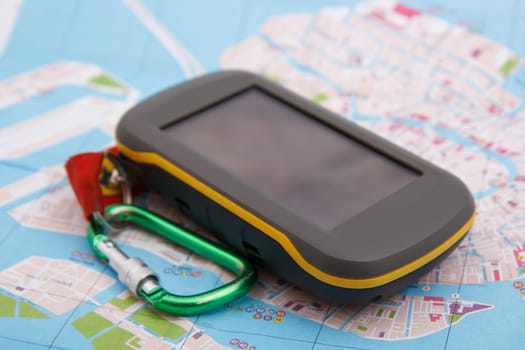 modern handheld GPS device on map background