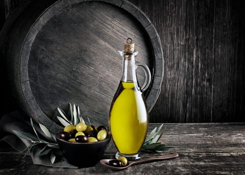 Bottle of Extra virgin healthy Olive oil with barrel background