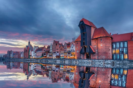 Gdansk beautiful sunset, view on Zuraw port crane and medieval facades, Poland.
