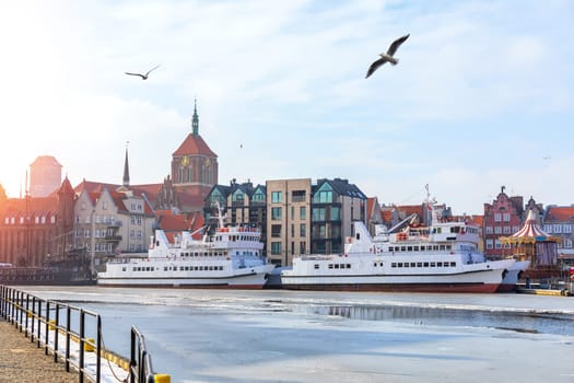 Ships in the Motlawa and the domes of the churches, Gdansk, Poland.