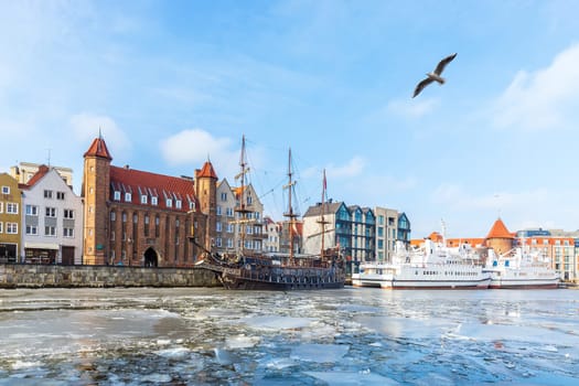 Winter Motlawa river in Gdansk, view on the Mariacka Gate and the ships.