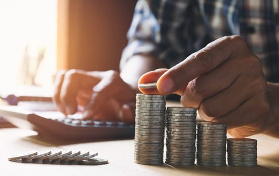 Hand drop a coin with money coin stack growing for business. financial and accounting concept.