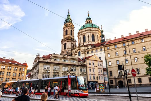 Prague, Czech Republic - August 18, 2018: Malostranske namesti - a square in Prague, St. Nicholas Church and a tram stop