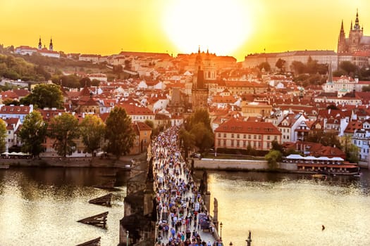 Panoramic view on Charles bridge and Prague sights at sunset.