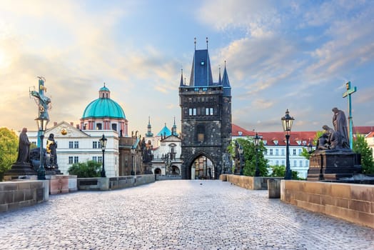 Charles Bridge leading to the Old Town Bridge Tower and St. Francis of Assisi Church, Prague, no people.