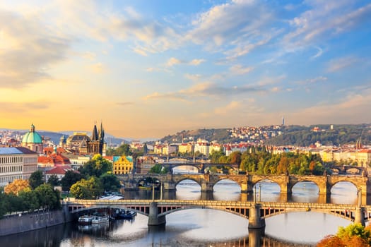 Charles Bridge and other bridges over the Vltava river and the Old Town of Prague view at sunrise.