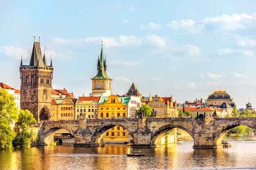 Charles Bridge, Prague towers and the National Theatre, summer day view.