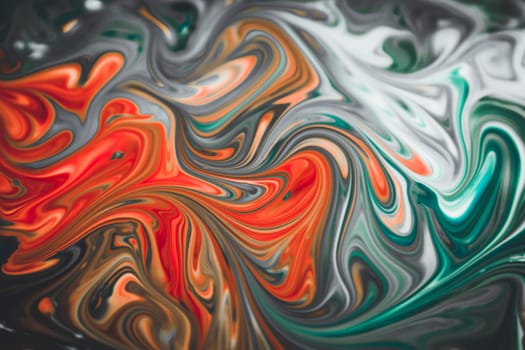 Colorful liquid paints mixed together creating modern abstract