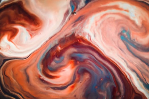 Colorful liquid paints mixed together creating modern abstract