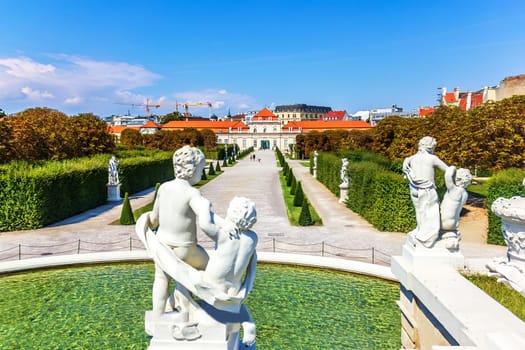 Statues on the fountain and view on Lower Belvedere Palace, Vienna.