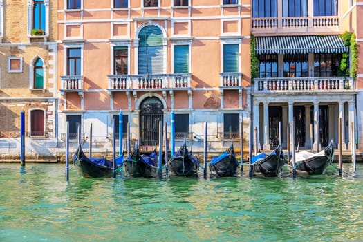 Gondolas moored on the Grand Canal of Venice, summer view.