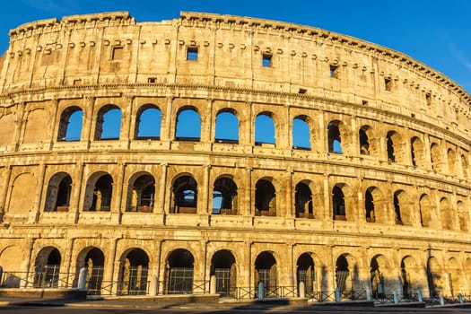 The Colosseum of Rome under the blue summer sky.