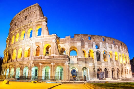 Coliseum in the evening in the lights under the starlit sky, Rome, Italy, no people.