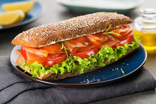 Sandwich with smoked salmon salad and tomato. Healthy food.
