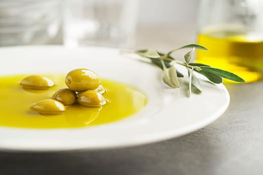 Healthy olive oil with olives ingredients close up