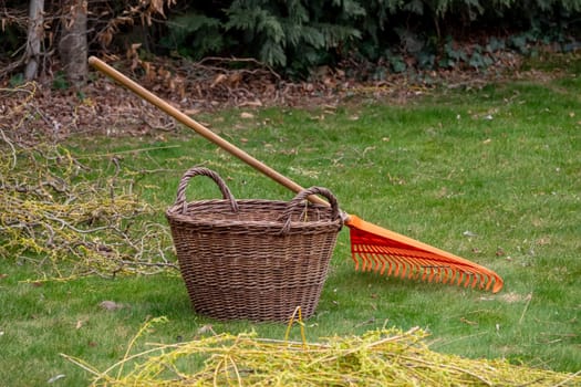 Orange rake next to a basket